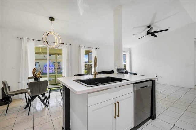 kitchen with white cabinetry, sink, ceiling fan, stainless steel dishwasher, and pendant lighting