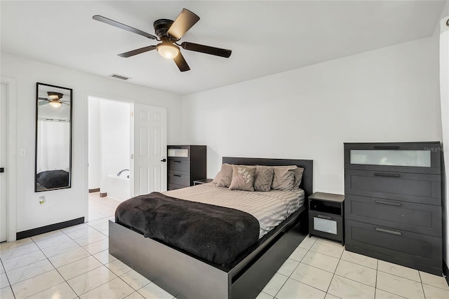 bedroom featuring ceiling fan, light tile patterned floors, and ensuite bath