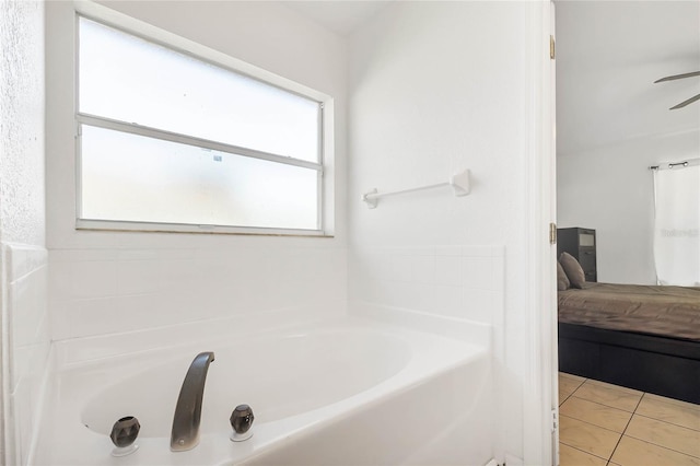 bathroom with tile patterned flooring and a bathtub