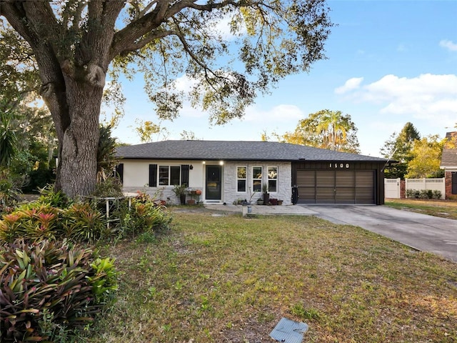 single story home featuring a garage and a front lawn