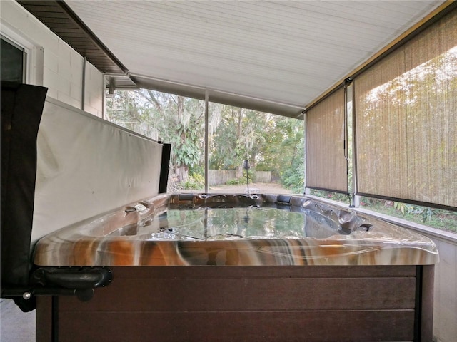 unfurnished sunroom with a wealth of natural light and a jacuzzi