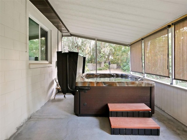 sunroom with a hot tub