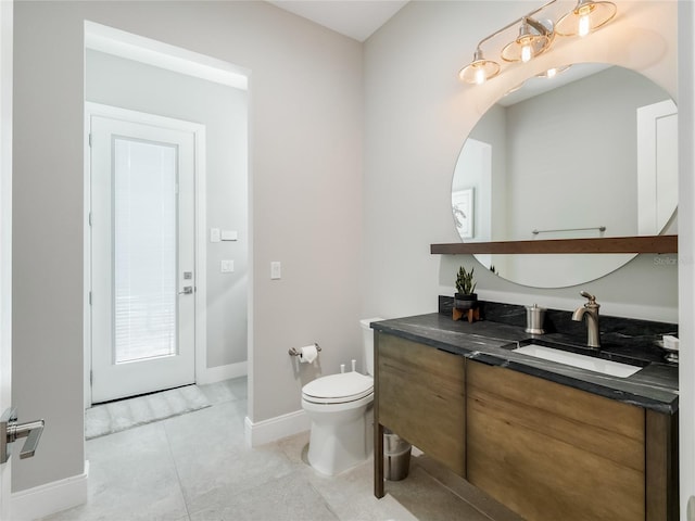 bathroom featuring tile patterned flooring, vanity, and toilet