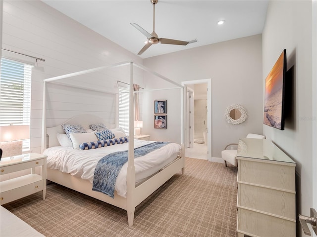 bedroom featuring carpet floors, ceiling fan, and connected bathroom