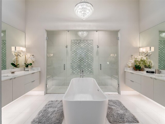 bathroom with tile patterned flooring, vanity, independent shower and bath, and a chandelier