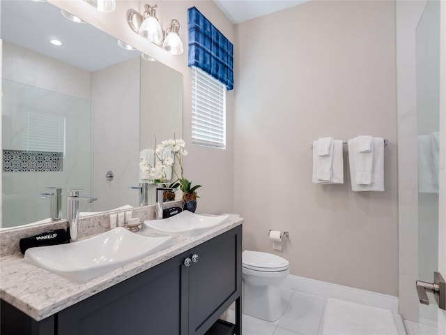 bathroom with tile patterned flooring, vanity, toilet, and tiled shower