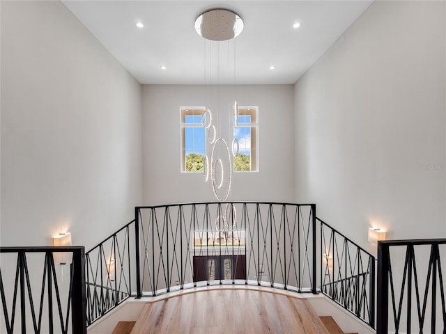 staircase with hardwood / wood-style floors