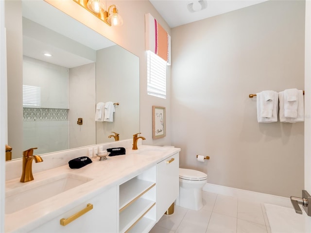 bathroom with a tile shower, tile patterned floors, vanity, and toilet