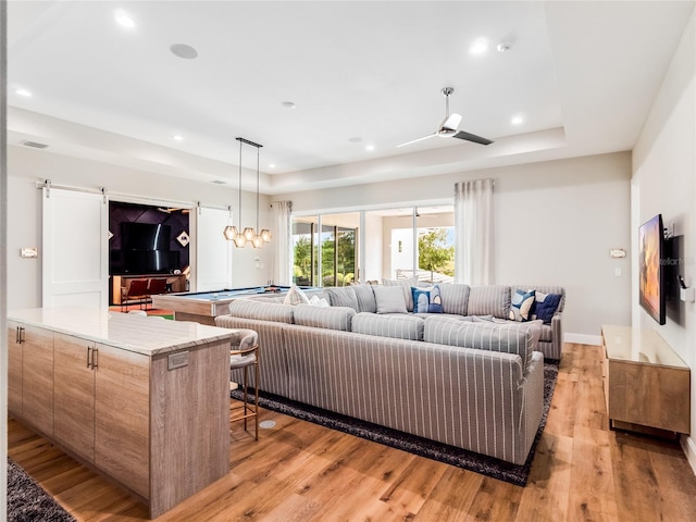 living room with ceiling fan, light hardwood / wood-style floors, and pool table