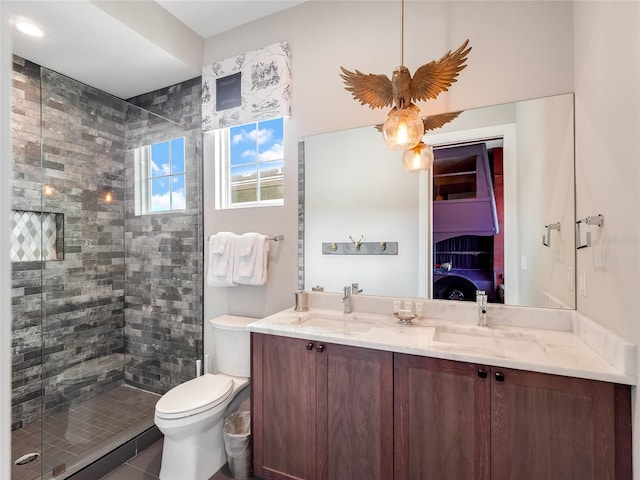 bathroom featuring walk in shower, vanity, and toilet