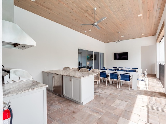 view of patio featuring ceiling fan and exterior kitchen