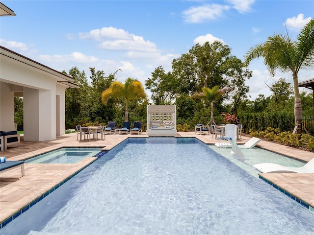 view of swimming pool with an in ground hot tub and a patio