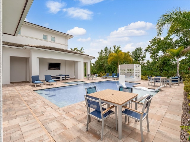 view of pool featuring an in ground hot tub, a fireplace, and a patio