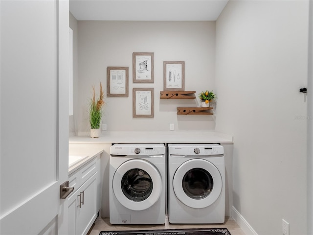 clothes washing area featuring cabinets, washer and dryer, and light tile patterned flooring