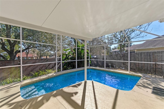 view of swimming pool with a patio and glass enclosure