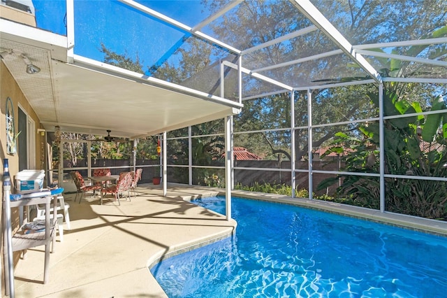 view of swimming pool featuring a lanai and a patio