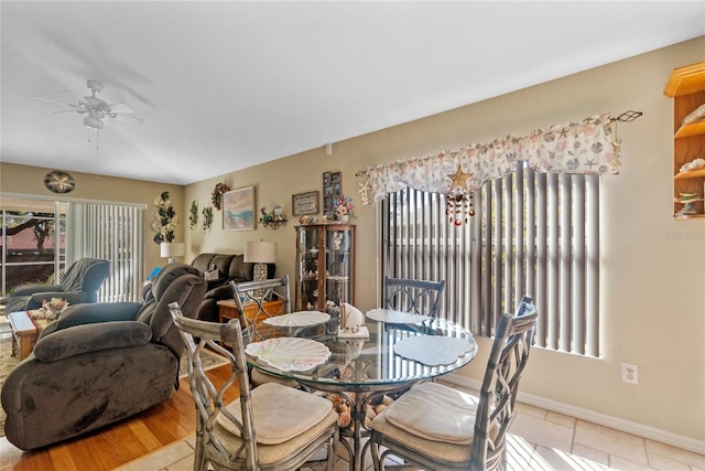 dining area with ceiling fan and light hardwood / wood-style flooring