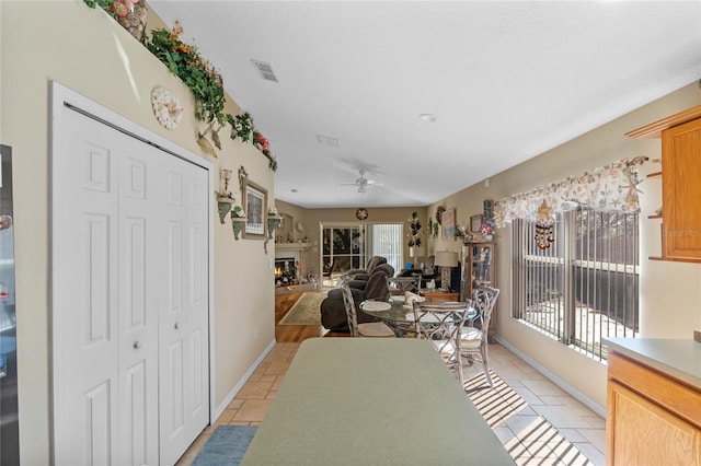 living room featuring ceiling fan and light tile patterned flooring