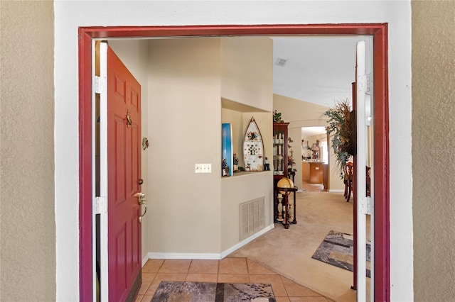 hallway featuring light carpet