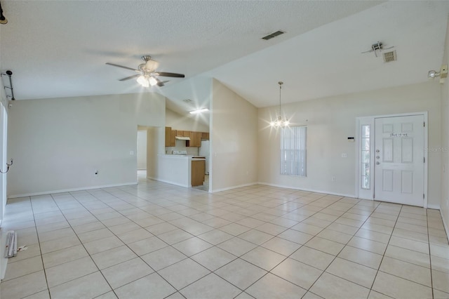 unfurnished living room featuring ceiling fan with notable chandelier, light tile patterned floors, and vaulted ceiling