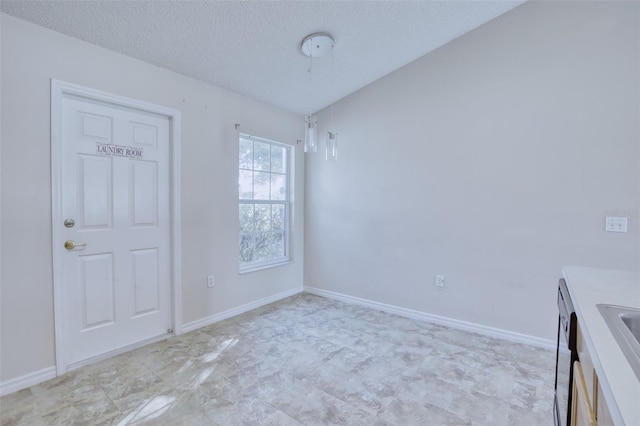 interior space featuring sink and a textured ceiling