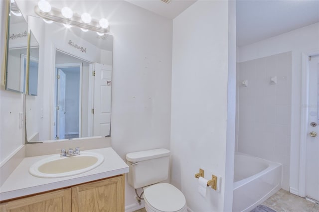 full bathroom featuring tiled shower / bath, vanity, and toilet