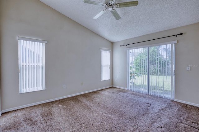 carpeted spare room with ceiling fan, lofted ceiling, and a textured ceiling