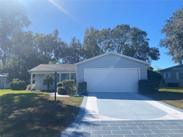 ranch-style home with a garage, a front yard, and driveway