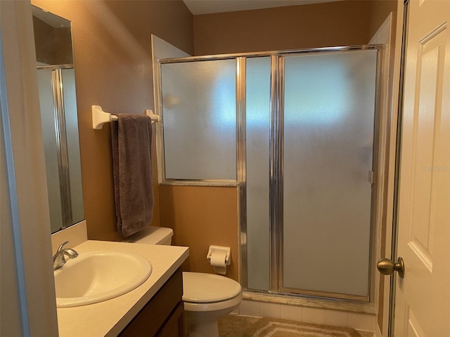 bathroom featuring walk in shower, tile patterned flooring, vanity, and toilet