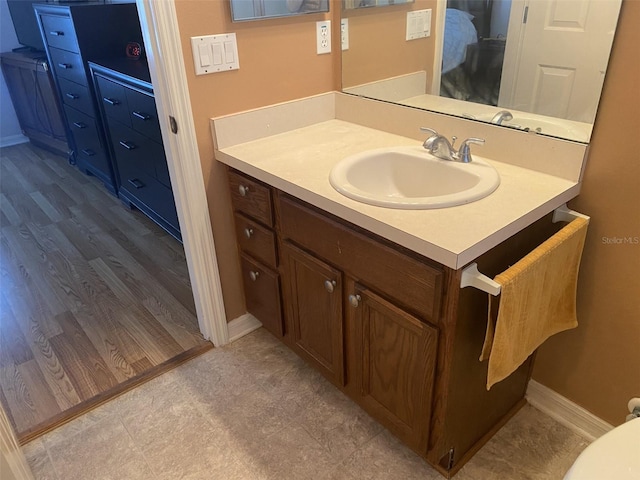 bathroom with vanity and wood-type flooring