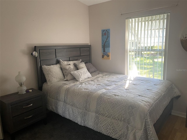 bedroom with dark hardwood / wood-style floors