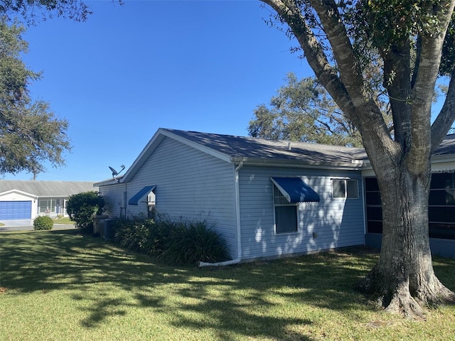 view of side of property featuring a yard