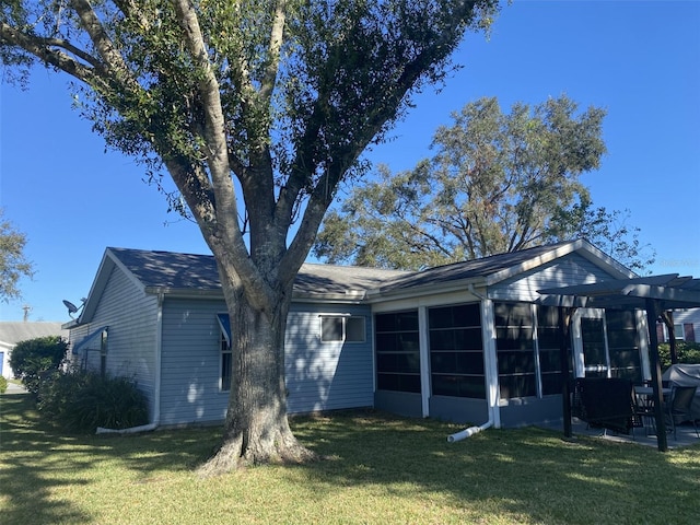 view of front of home with a sunroom and a front lawn