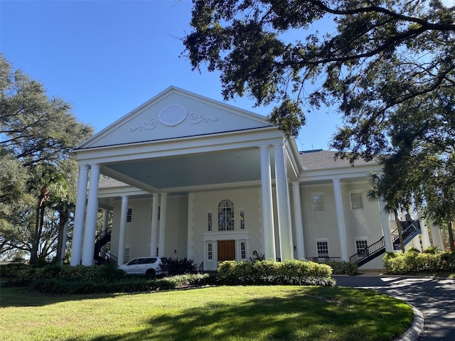 greek revival inspired property with a front yard