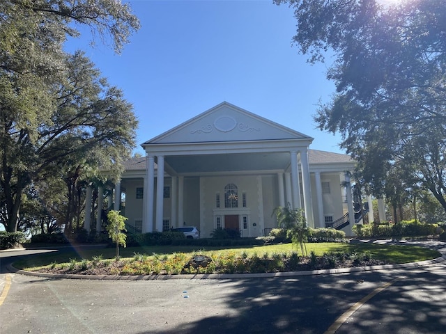 neoclassical / greek revival house with a front yard