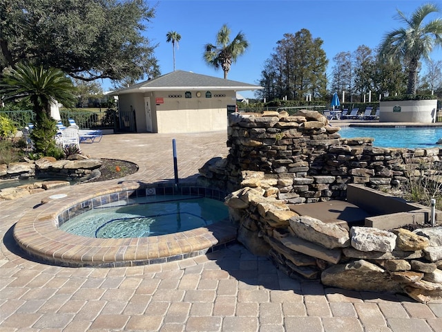 view of pool with a community hot tub and a patio area