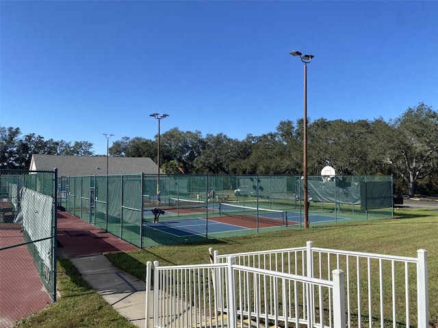 view of sport court featuring a lawn