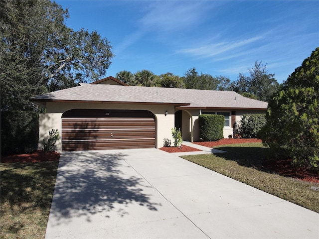 single story home featuring a garage and a front lawn