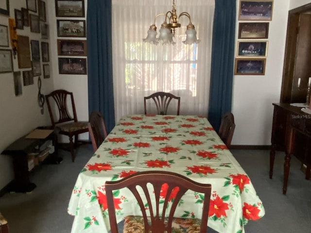 carpeted dining area featuring an inviting chandelier