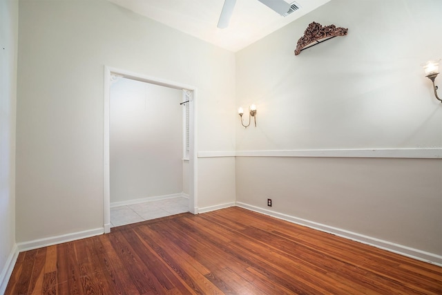 empty room featuring ceiling fan and light hardwood / wood-style flooring