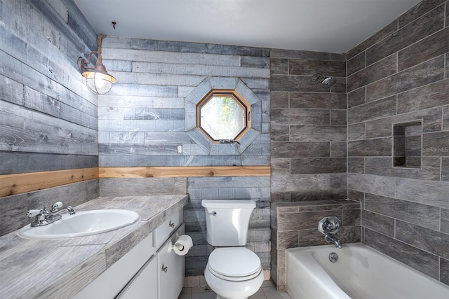 full bathroom featuring vanity, bathing tub / shower combination, tile patterned floors, toilet, and tile walls