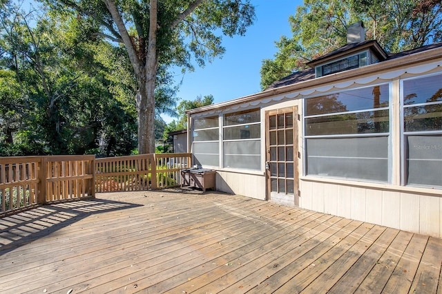 wooden deck featuring a sunroom