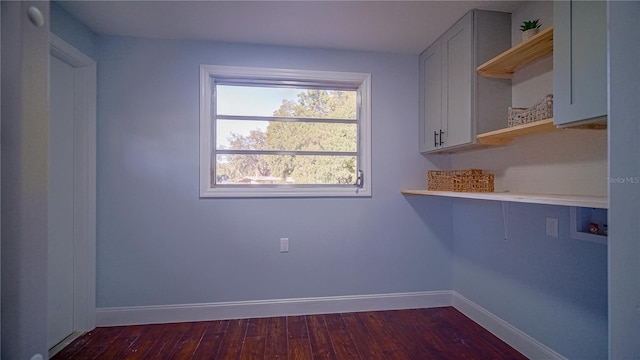 laundry area featuring cabinets, hookup for a washing machine, and dark hardwood / wood-style flooring