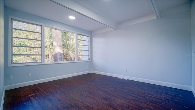 spare room featuring dark hardwood / wood-style floors and a healthy amount of sunlight