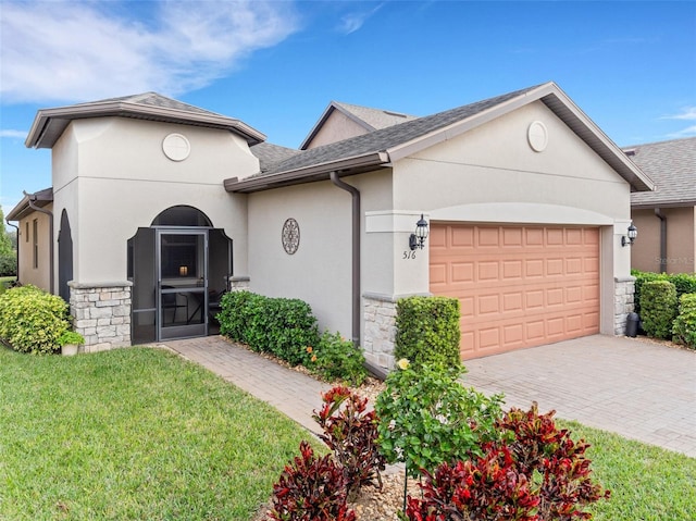 view of front of house featuring a garage and a front lawn