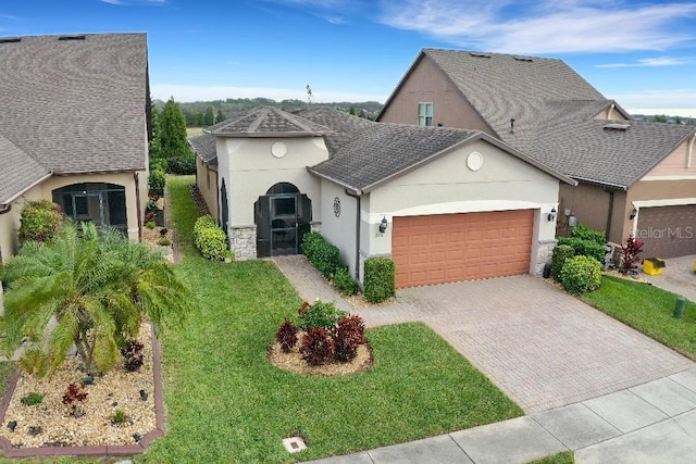 view of front facade featuring a garage and a front lawn