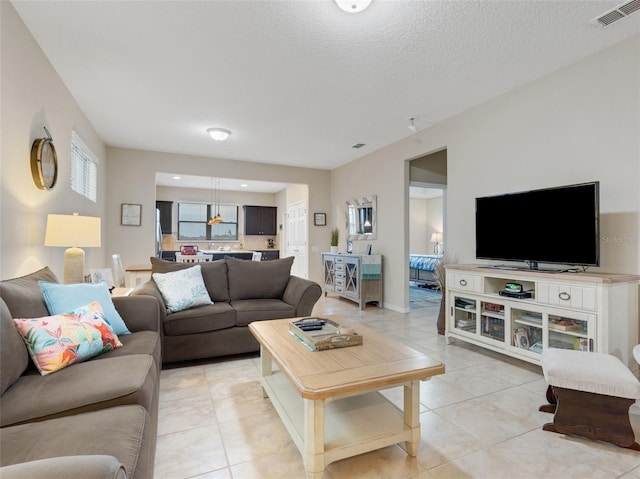 tiled living room with a textured ceiling