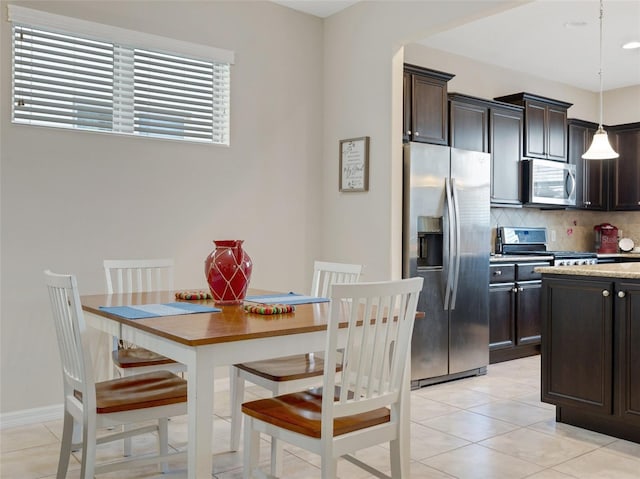 dining area featuring light tile patterned floors