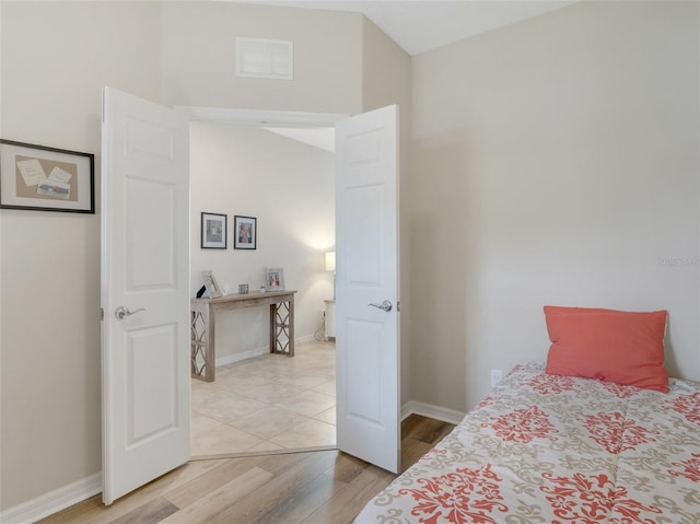 bedroom with hardwood / wood-style flooring