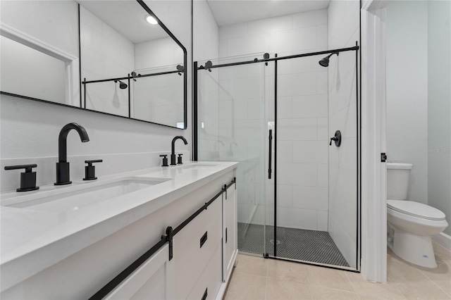 bathroom with tile patterned flooring, vanity, an enclosed shower, and toilet